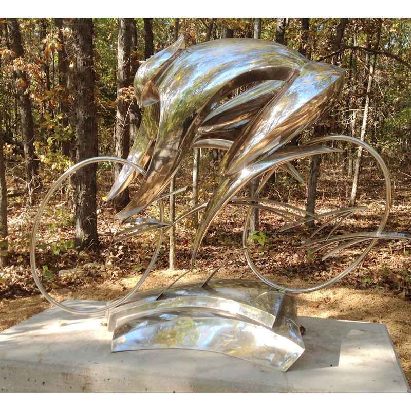 stainless steel man riding bicycle sculpture