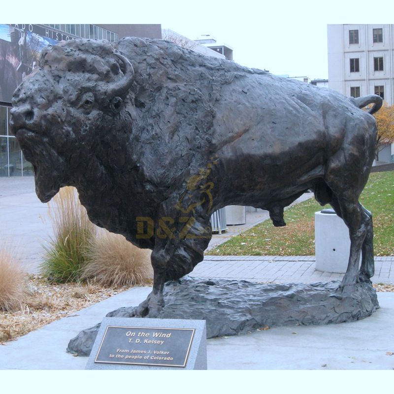 Bronze cow animal sculpture in large outdoor plaza