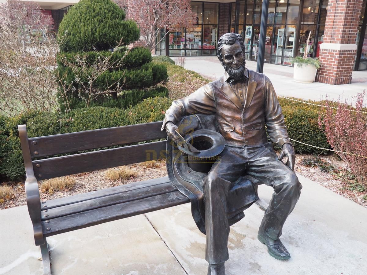 Outdoor bronze franklin sitting on a bench statue for the University