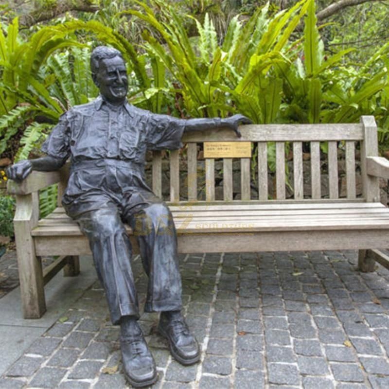 statue of man sitting in chair