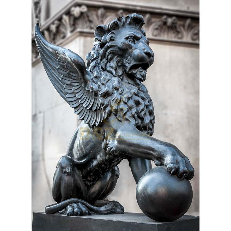 lion statue with ball