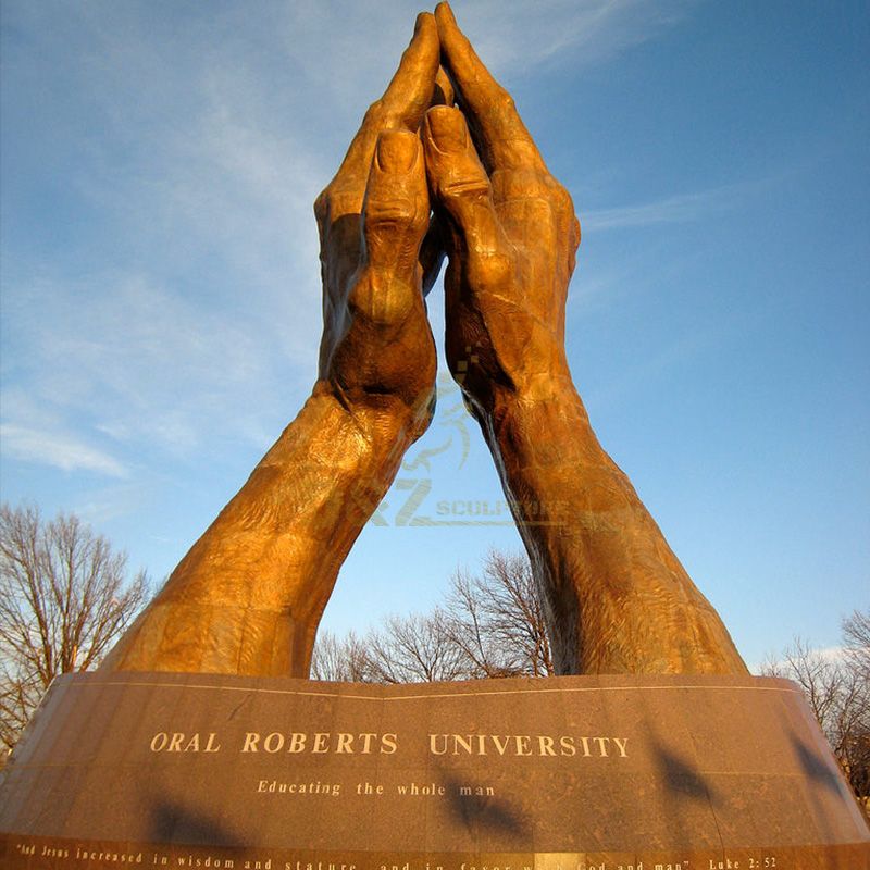 large praying hands statue