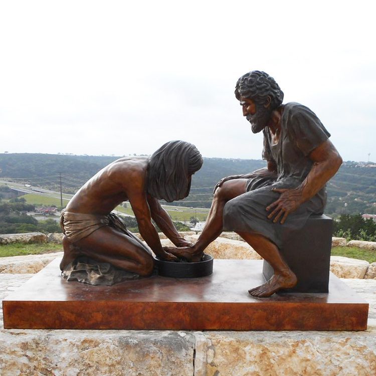 Bronze statue of Jesus washing the disciple Peter's feet