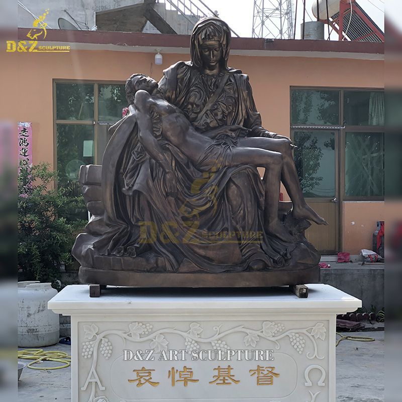 virgin mary holding jesus statue