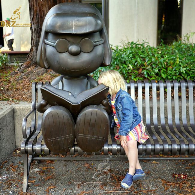 girl reading book garden statue