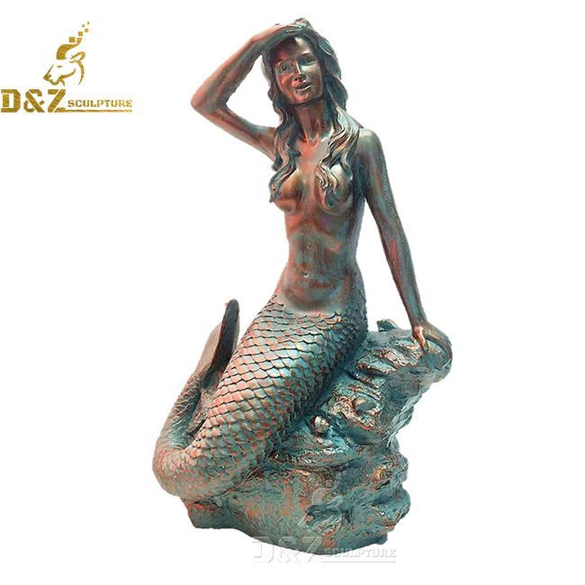 mermaid sitting on a rock statue