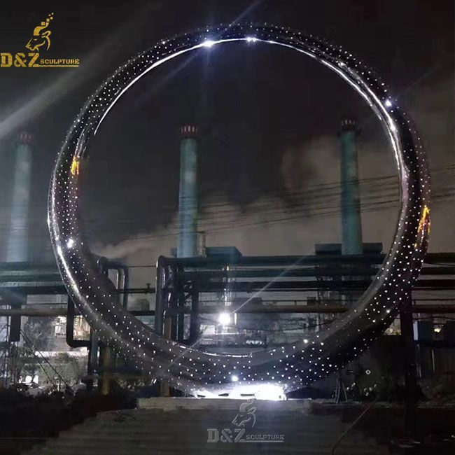 large metal ring sculpture with light