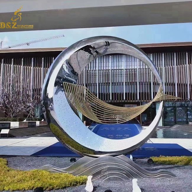 large metal sculpture of fish and ring circle