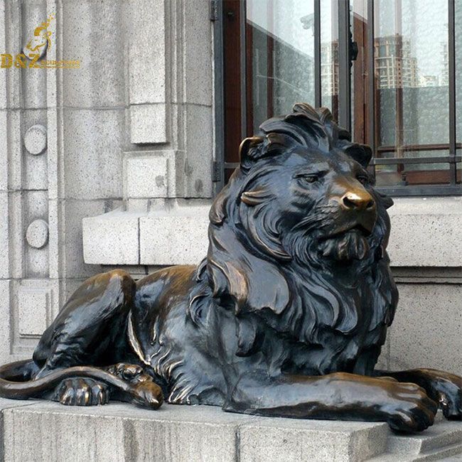 Bronze lion statue lying down outside house