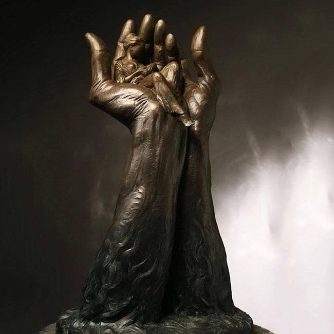 Bronze hand holding mother and child sculpture Agape by José Ismael Fernandez Bronze hand holding mother and child sculpture Agape by José Ismael Fernandez
