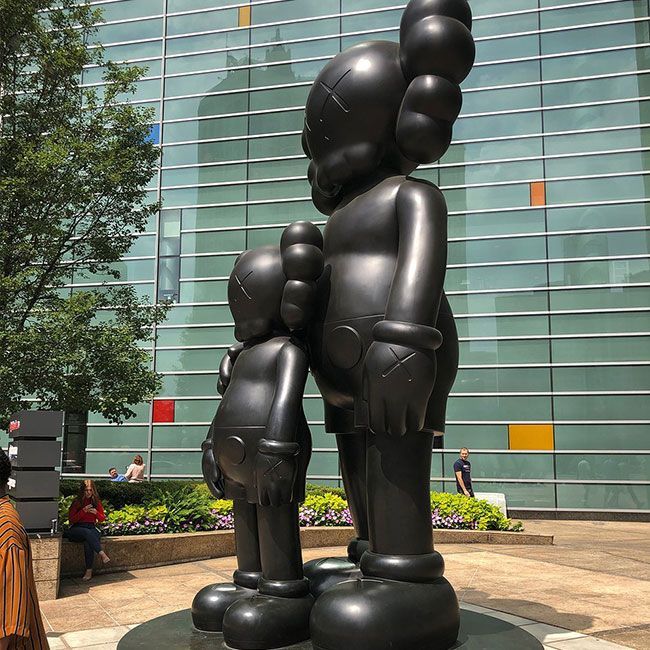 Outdoor large bronze waiting statue by Kaws