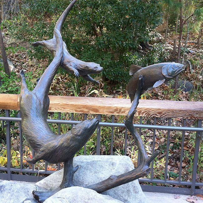 Outdoor bronze sea otter garden statue