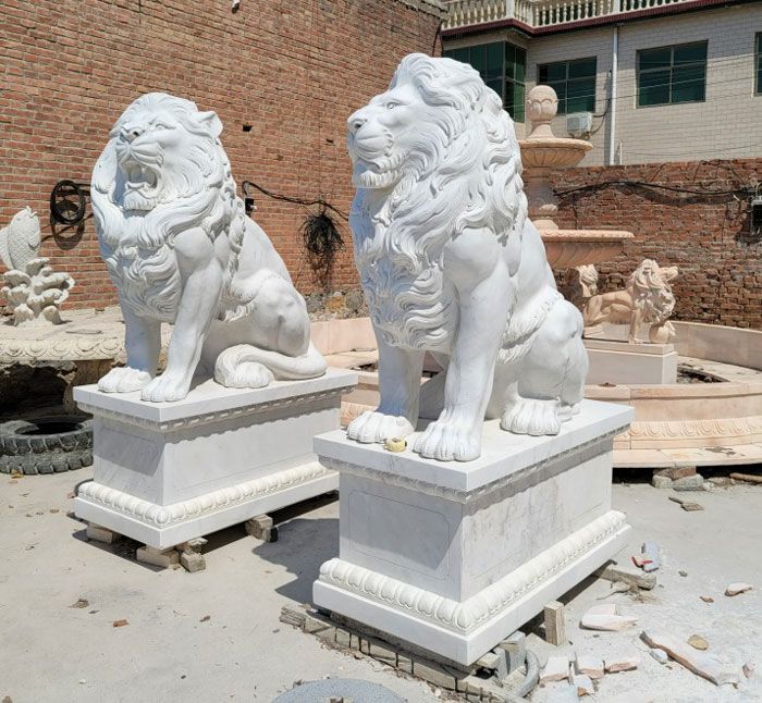 life size marble outdoor sitting white lion statues in front of house