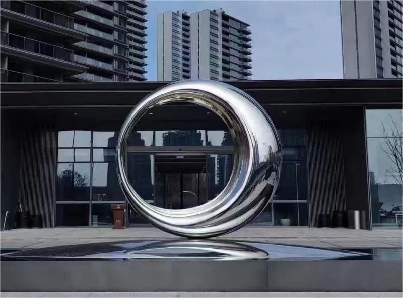 What is the role of large metal sculptures in urban space?