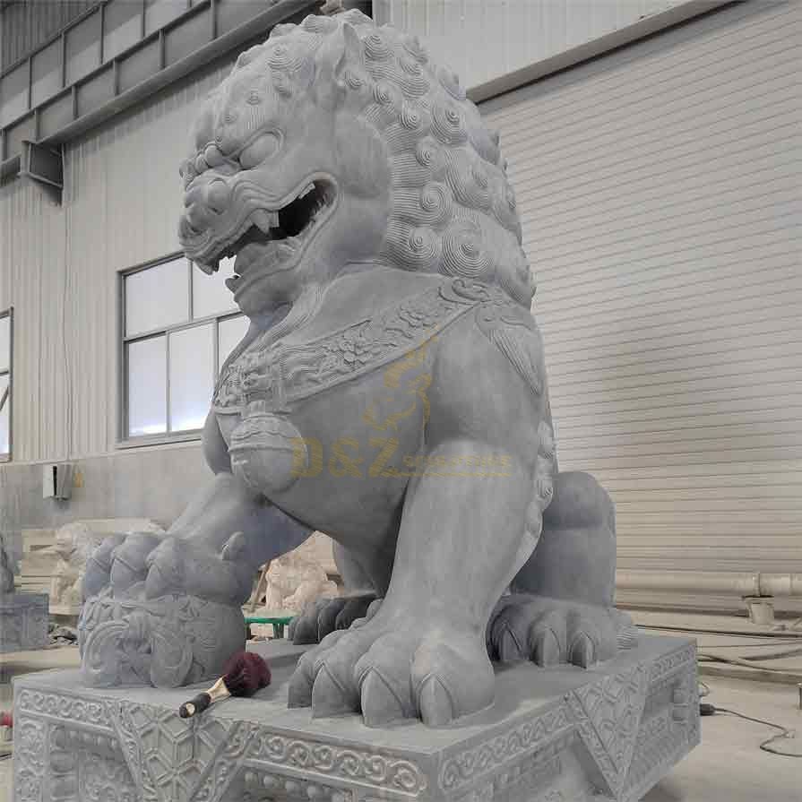 A male marble Chinese lion dog statue with hydrangea feet and feng shui ornament
