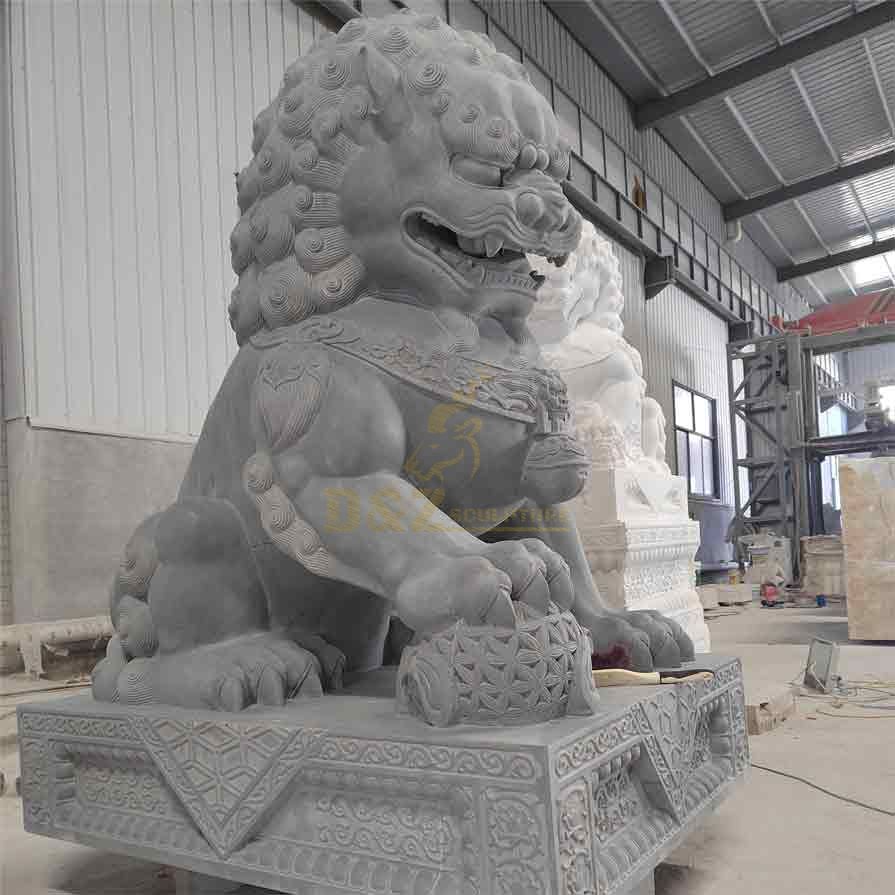 A male marble Chinese lion dog statue with hydrangea feet and feng shui ornament