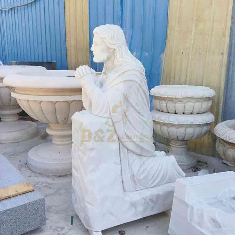 white marble jesus kneeling in prayer statue