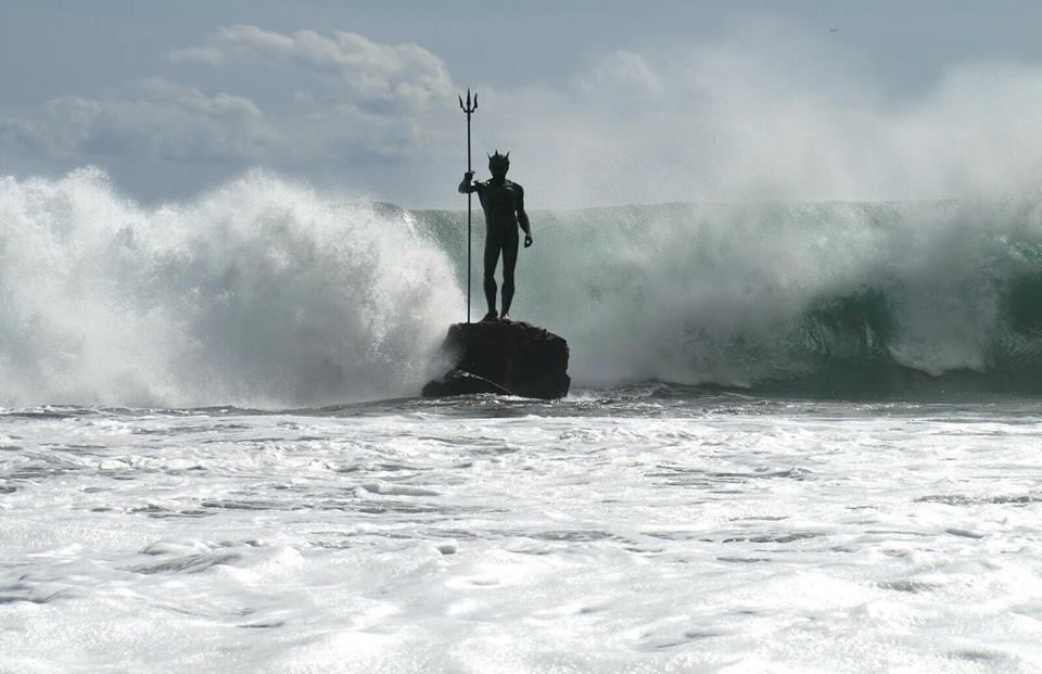 famous poseidon statue in the sea