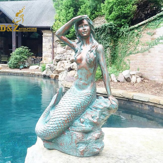 mermaid sitting on a rock statue