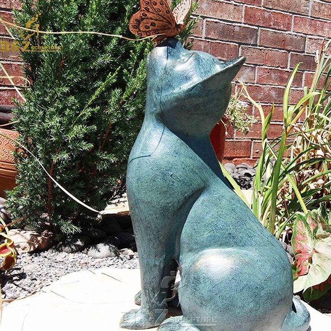cat with butterfly on nose garden statue