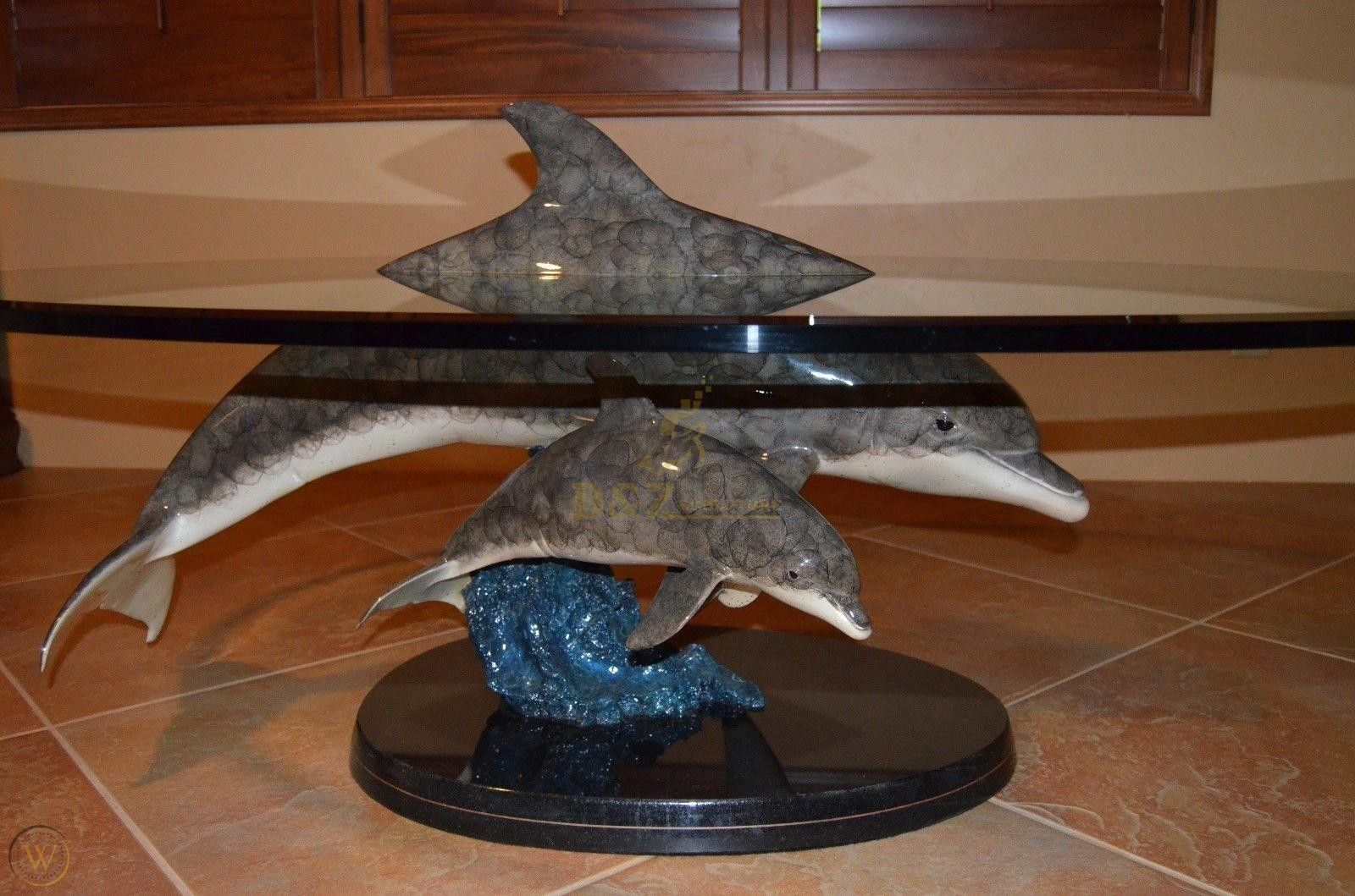 glass coffee table with dolphin base