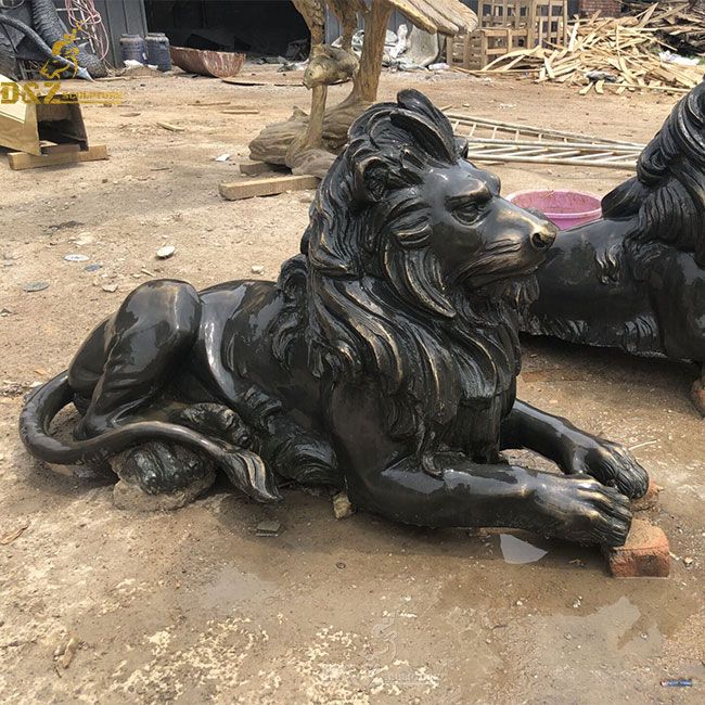 Bronze lion statue lying down outside house