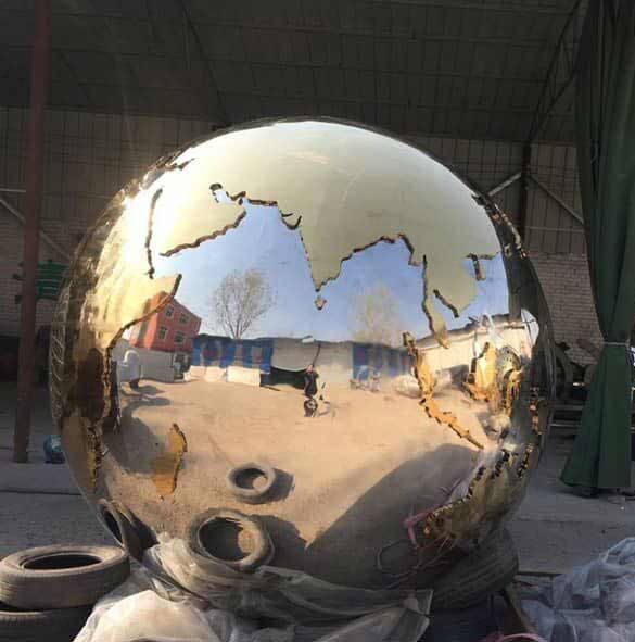globe ball on book sculpture