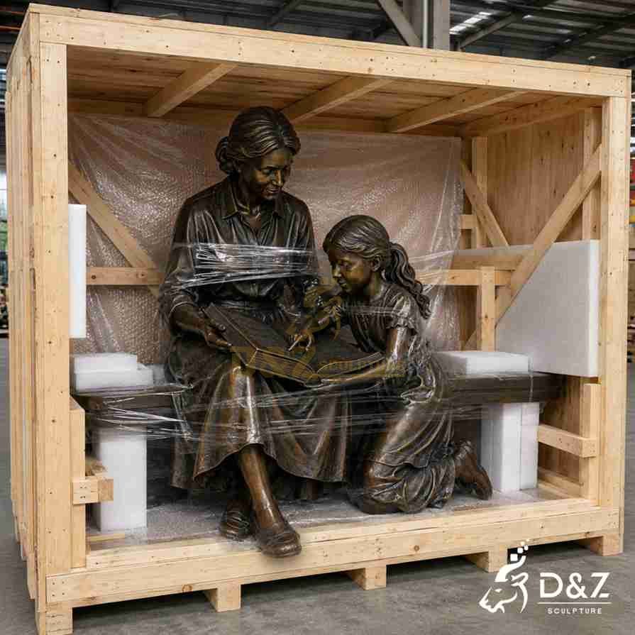 Bronze mother‑and‑girl reading statue securely packed inside custom solid wooden export crate with foam wrap Bronze mother‑and‑girl reading statue securely packed inside custom solid wooden export crate with foam wrap