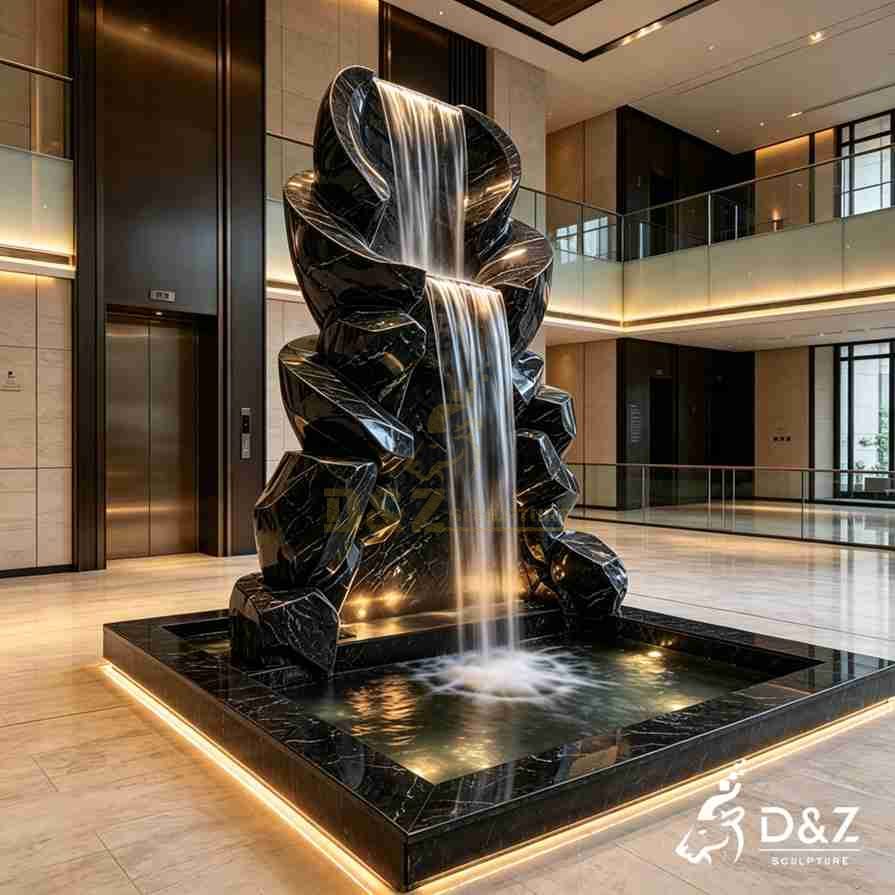 Modern zen fountain with curved black marble forms and a tall central waterfall Modern zen fountain with curved black marble forms and a tall central waterfall