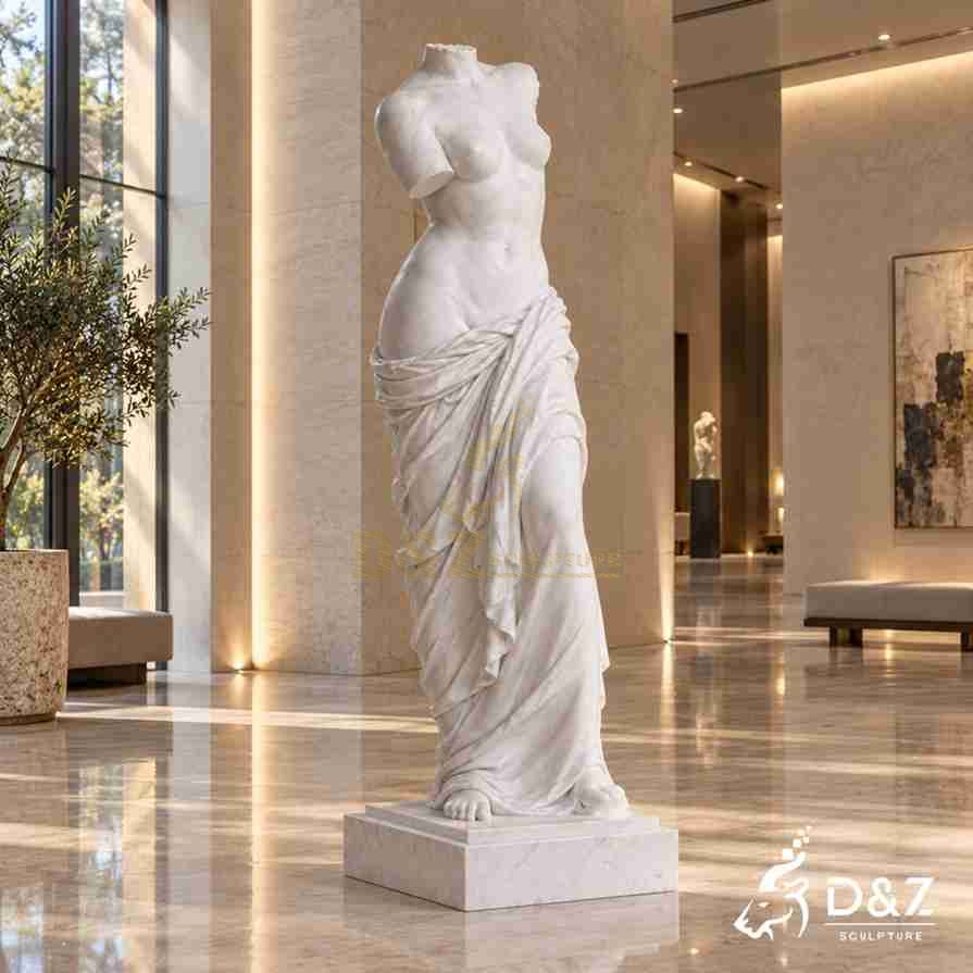 Side view of a hand-carved headless Venus statue in a modern hotel lobby