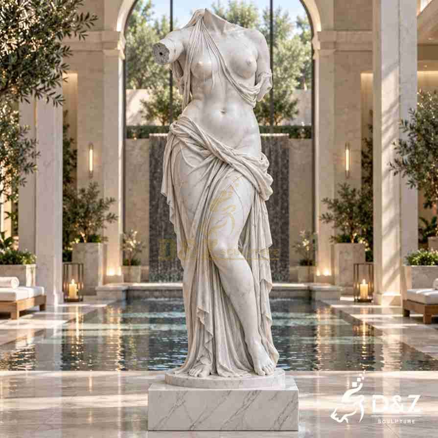 Draped headless and armless Venus statue beside an indoor spa pool