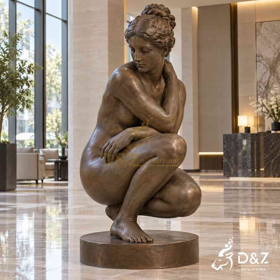Bronze Crouching Aphrodite statue with compact pose and antique brown patina in a modern hotel lobby