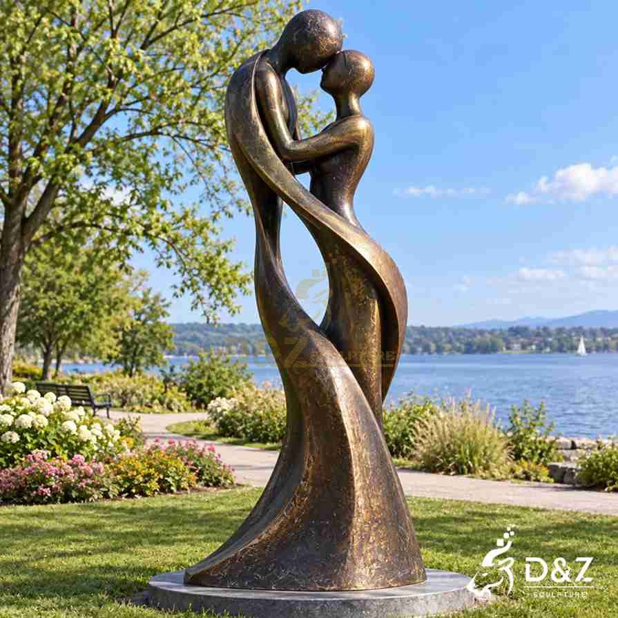 Abstract bronze love sculpture with embracing couple figures forming a heart-shaped negative space between their bodies Abstract bronze love sculpture with embracing couple figures forming a heart-shaped negative space between their bodies