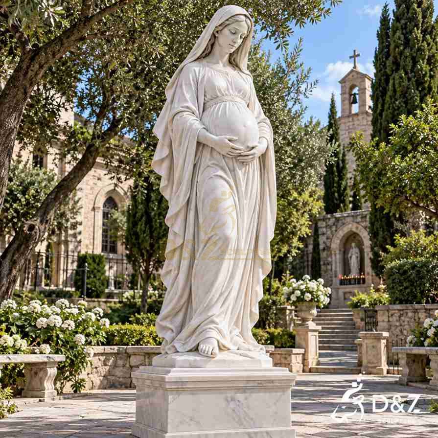 Large white marble pregnant Mary statue gently cradling her belly in a church prayer garden with flowers, stone pathways, and a bell tower. Large white marble pregnant Mary statue gently cradling her belly in a church prayer garden with flowers, stone pathways, and a bell tower.