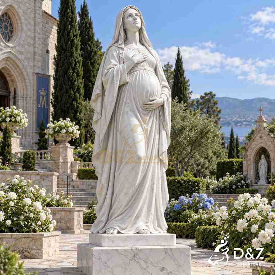 Pregnant Virgin Mary statue in white marble with one hand over her heart and the other supporting her belly in a Marian prayer garden. Pregnant Virgin Mary statue in white marble with one hand over her heart and the other supporting her belly in a Marian prayer garden.