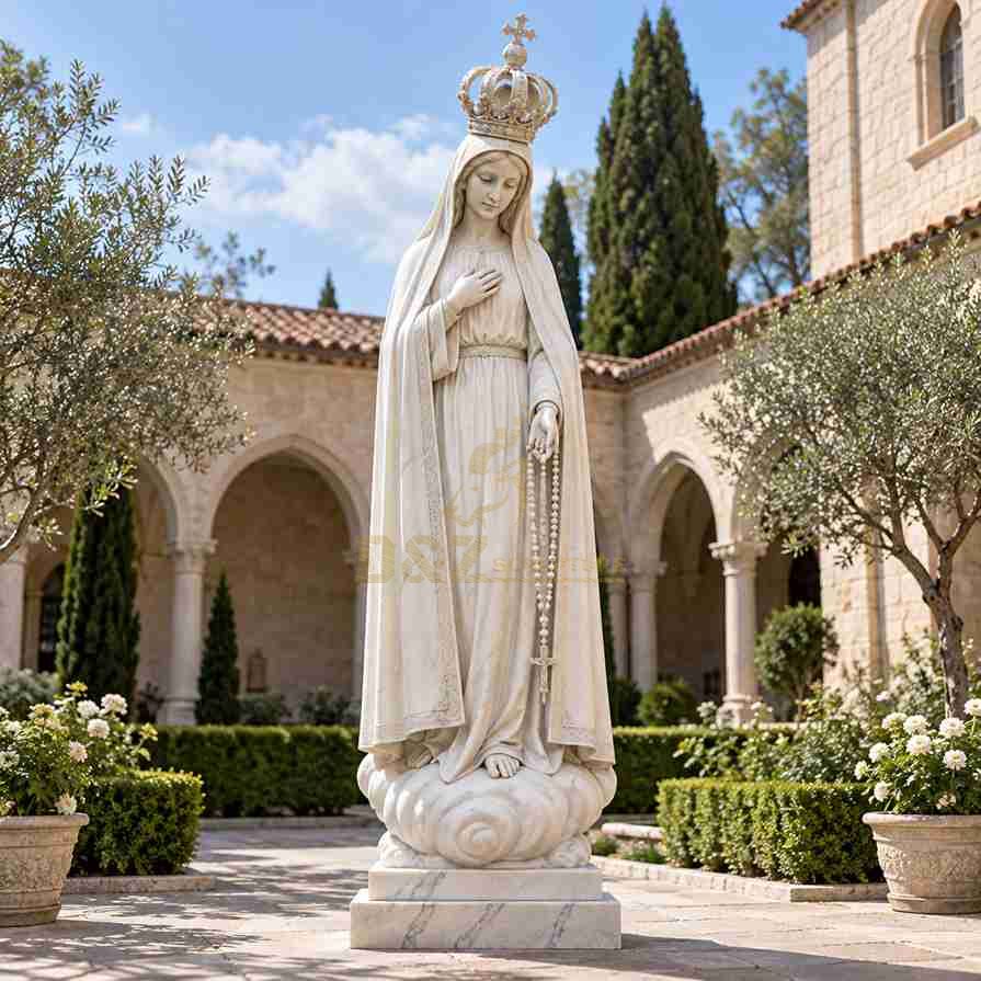 White marble Our Lady of Fatima statue wearing a crown, with one hand over her chest and the other holding a rosary with a cross in a monastery courtyard. White marble Our Lady of Fatima statue wearing a crown, with one hand over her chest and the other holding a rosary with a cross in a monastery courtyard.