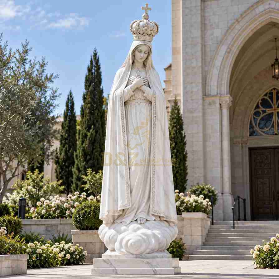 Large white marble Virgin Mary statue wearing a cross-topped crown, with both hands crossed over her chest and a flowing robe, displayed outside a church. Large white marble Virgin Mary statue wearing a cross-topped crown, with both hands crossed over her chest and a flowing robe, displayed outside a church.