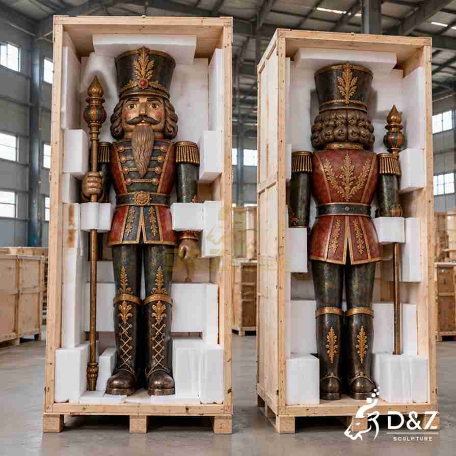 Front and rear packaging views of a bronze nutcracker soldier statue protected by foam blocks inside custom wooden shipping crates. Front and rear packaging views of a bronze nutcracker soldier statue protected by foam blocks inside custom wooden shipping crates.