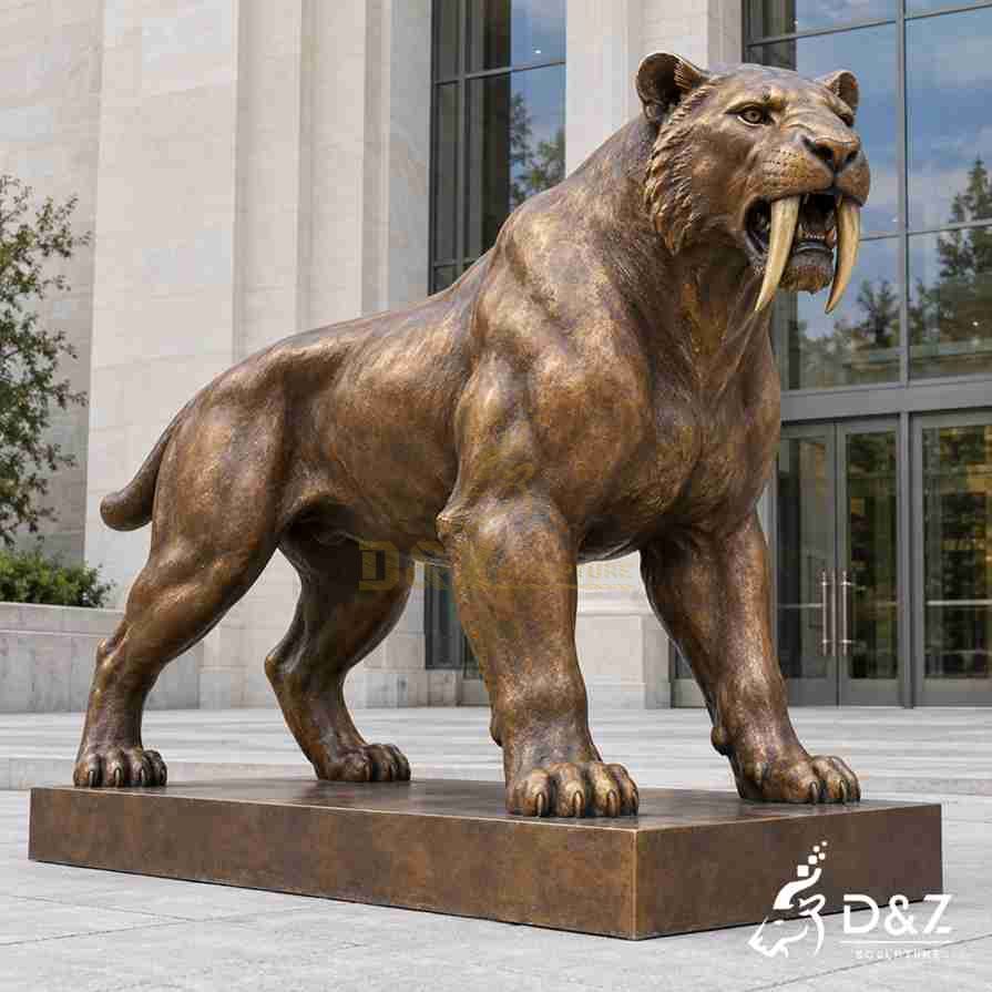 Bronze saber-toothed cat statue with long curved fangs, a muscular body and a short tail on a rectangular base.